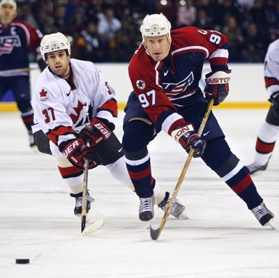 Jeremy Roenick (R) of theUSA moves the puck before